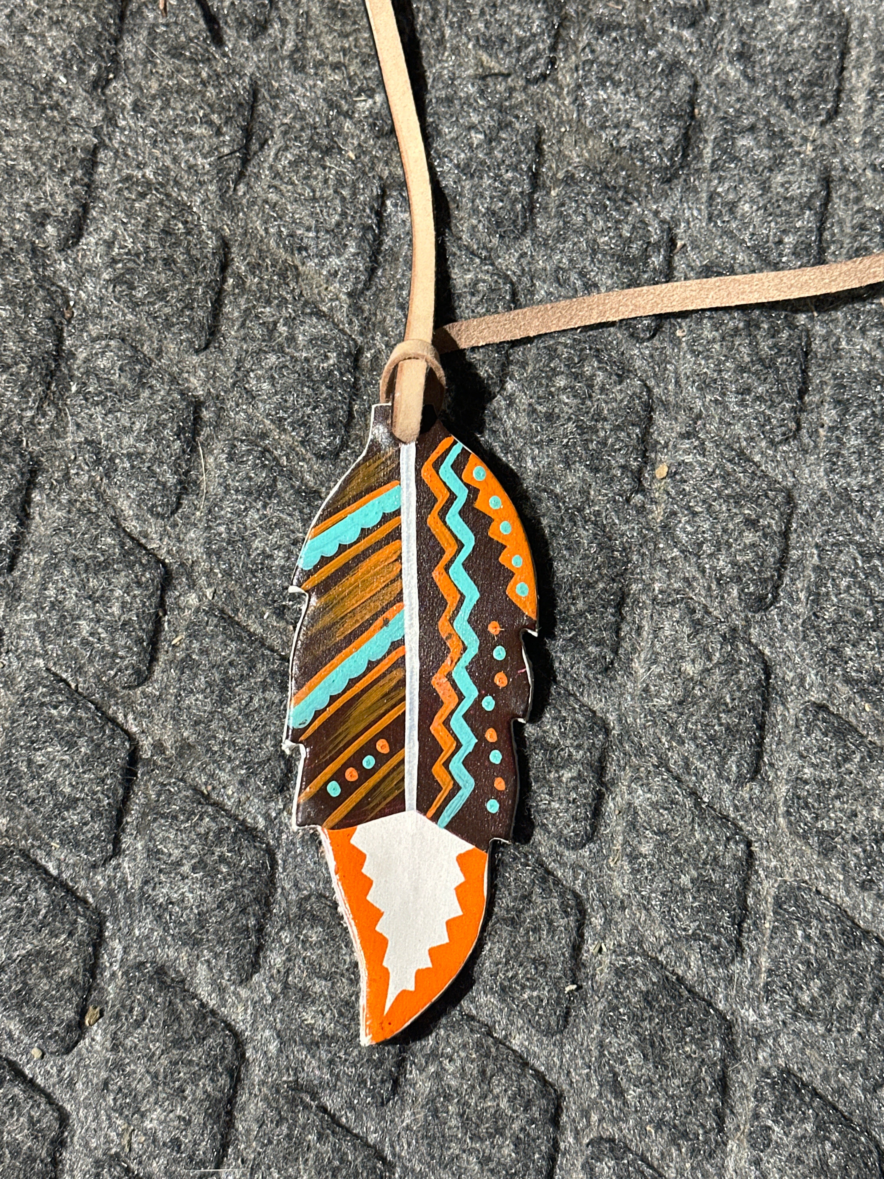 Organic tone painted tie on saddle feather