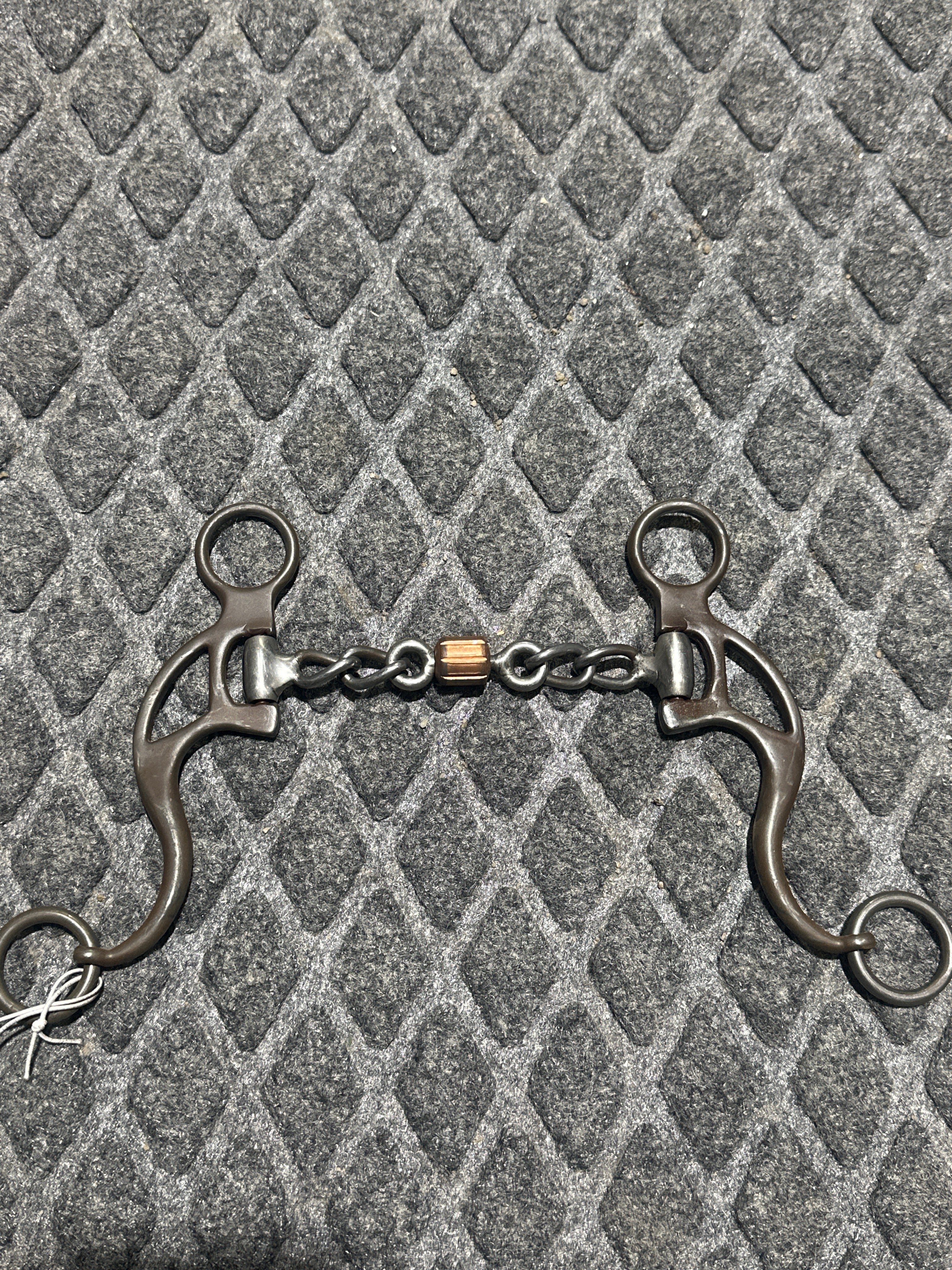 Curved shank chain bit with roller