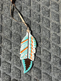 Orange/white/turquoise painted feather tie on saddle charm