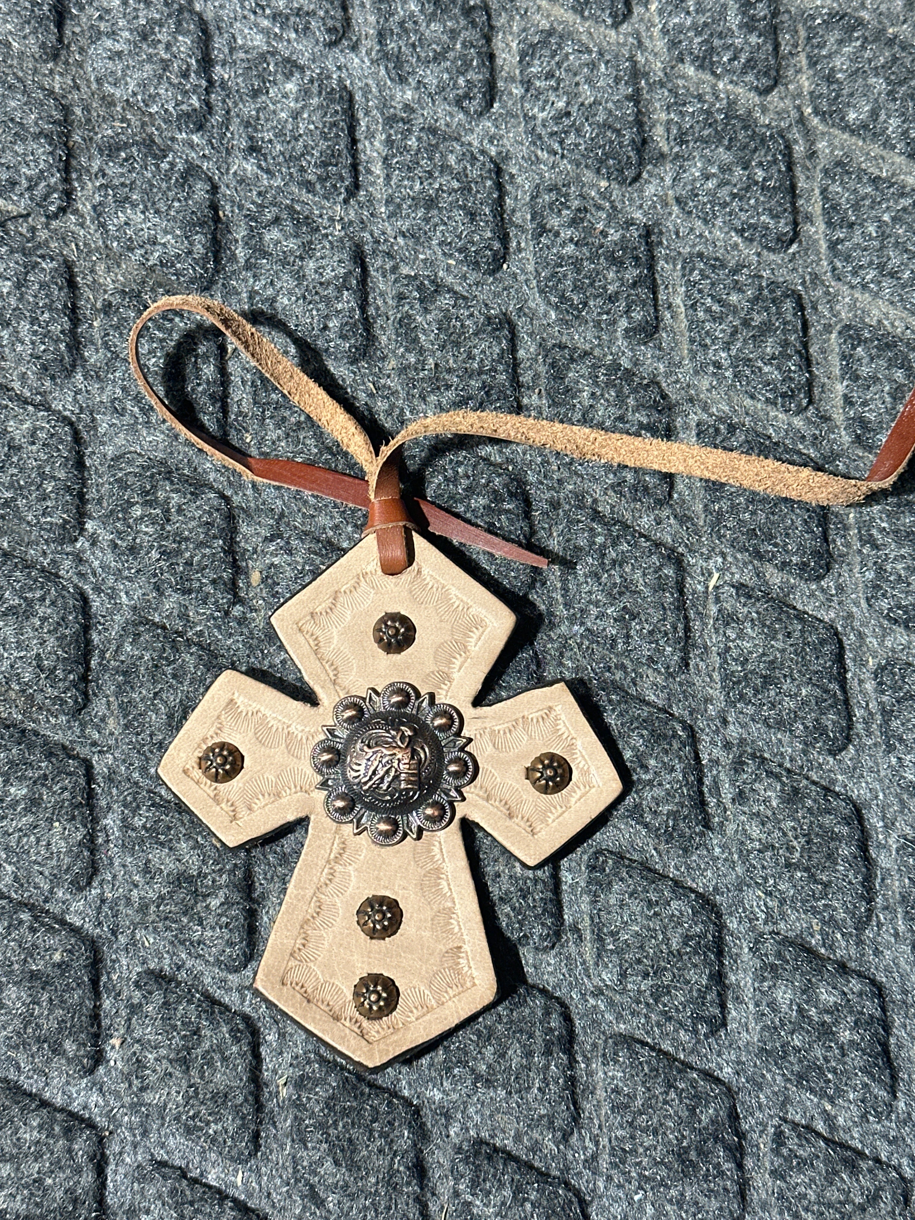 Barrel racer concho on light tone cross tie on saddle charm