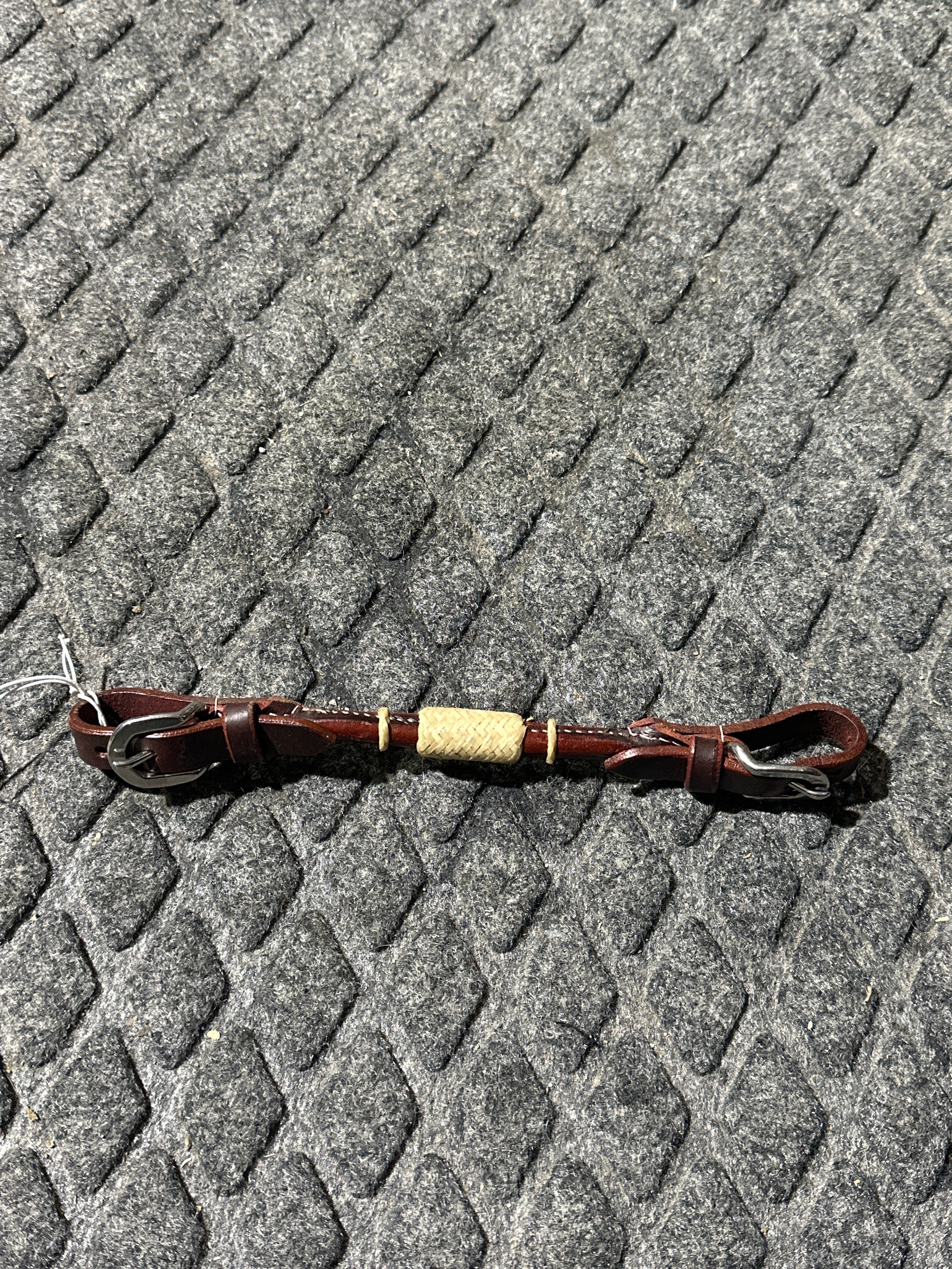 Rolled dark leather with rawhide chin strap
