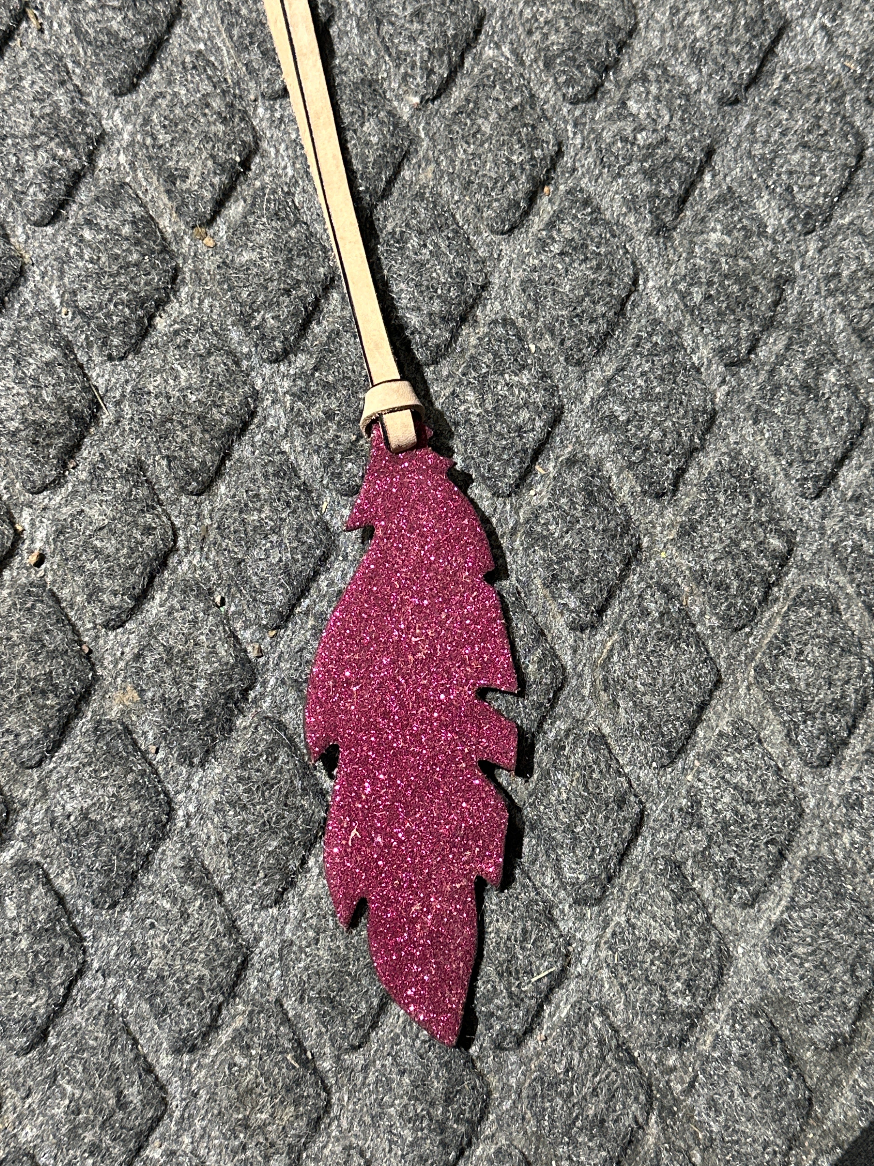 Pink sparkley tie on saddle feather